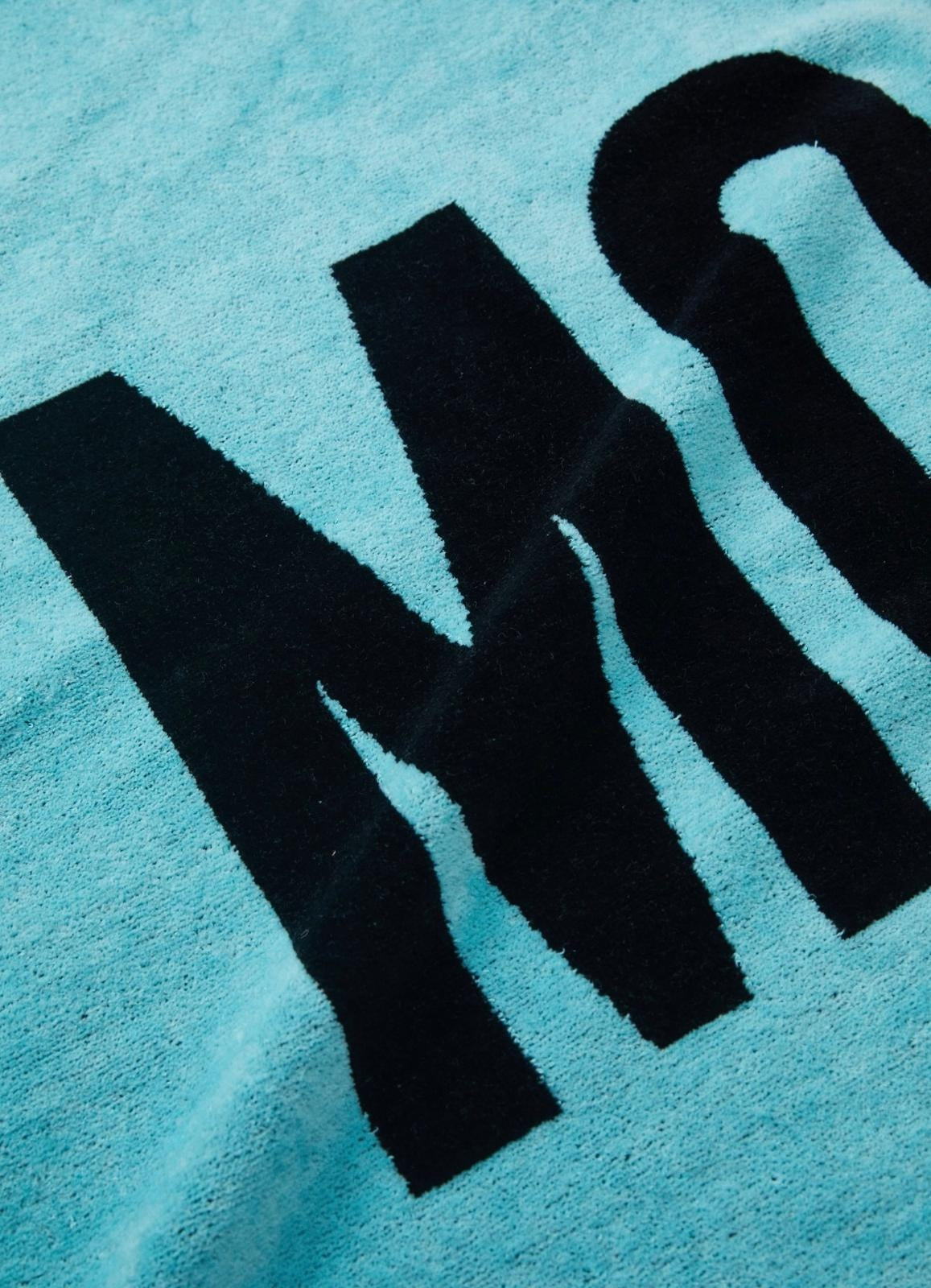 Telo mare Moschino Beachwear con logo e grafica a contrasto