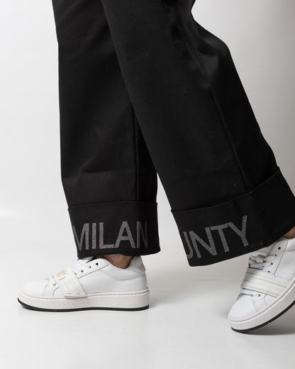 Pantalone Marcelo Burlon svasato con risvolto logato donna