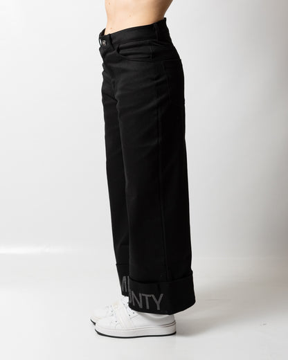 Pantalone Marcelo Burlon svasato con risvolto logato donna